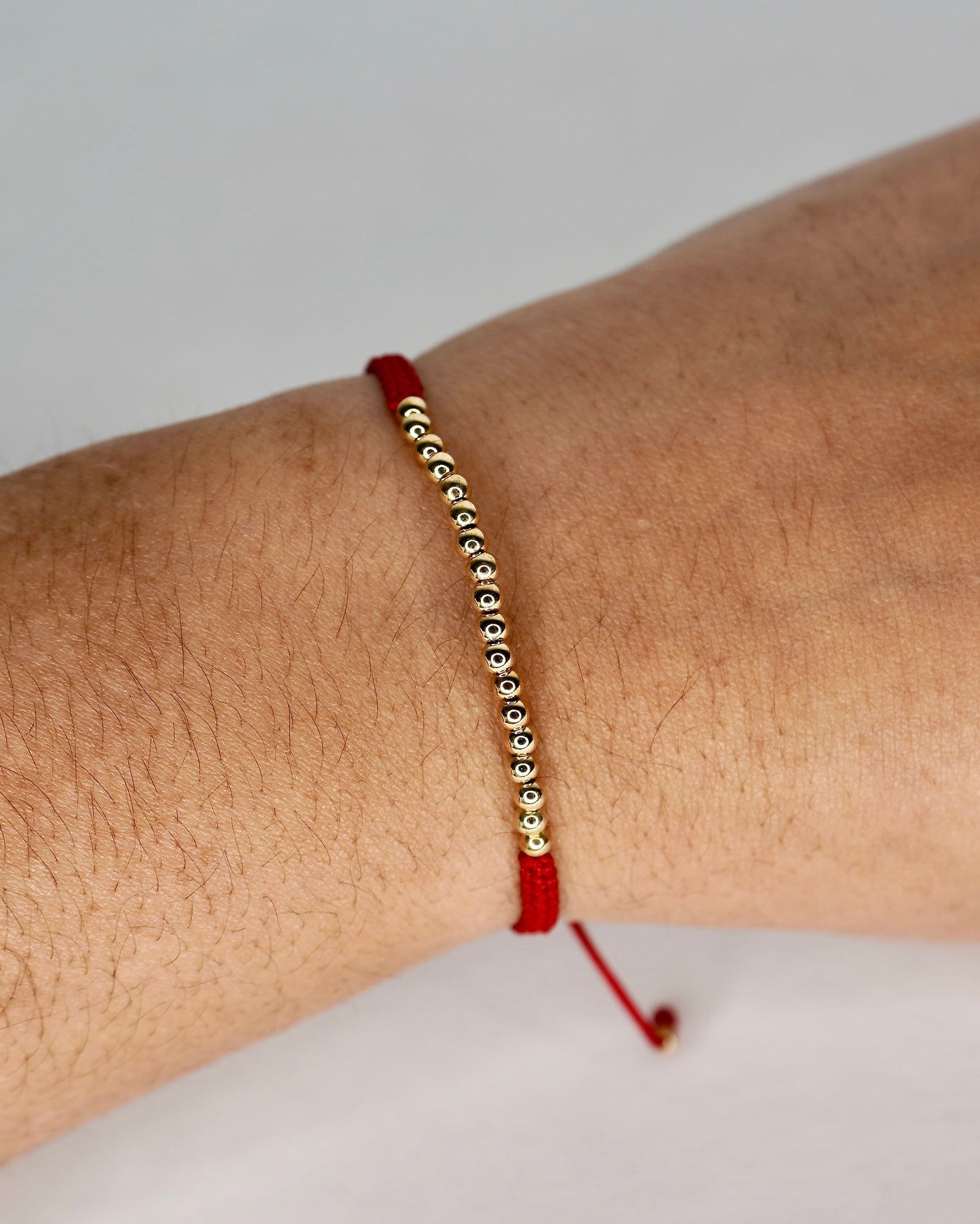 Red String Bracelet with Laminated Gold Beads